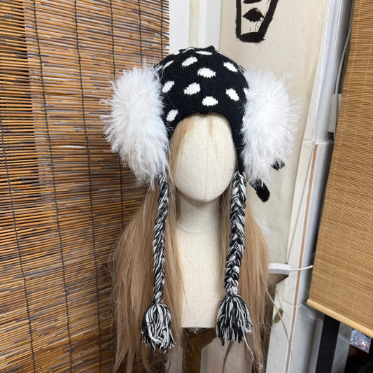 Black and white polka dot knit earflap hat with big white fur pom poms y2k aesthetic
