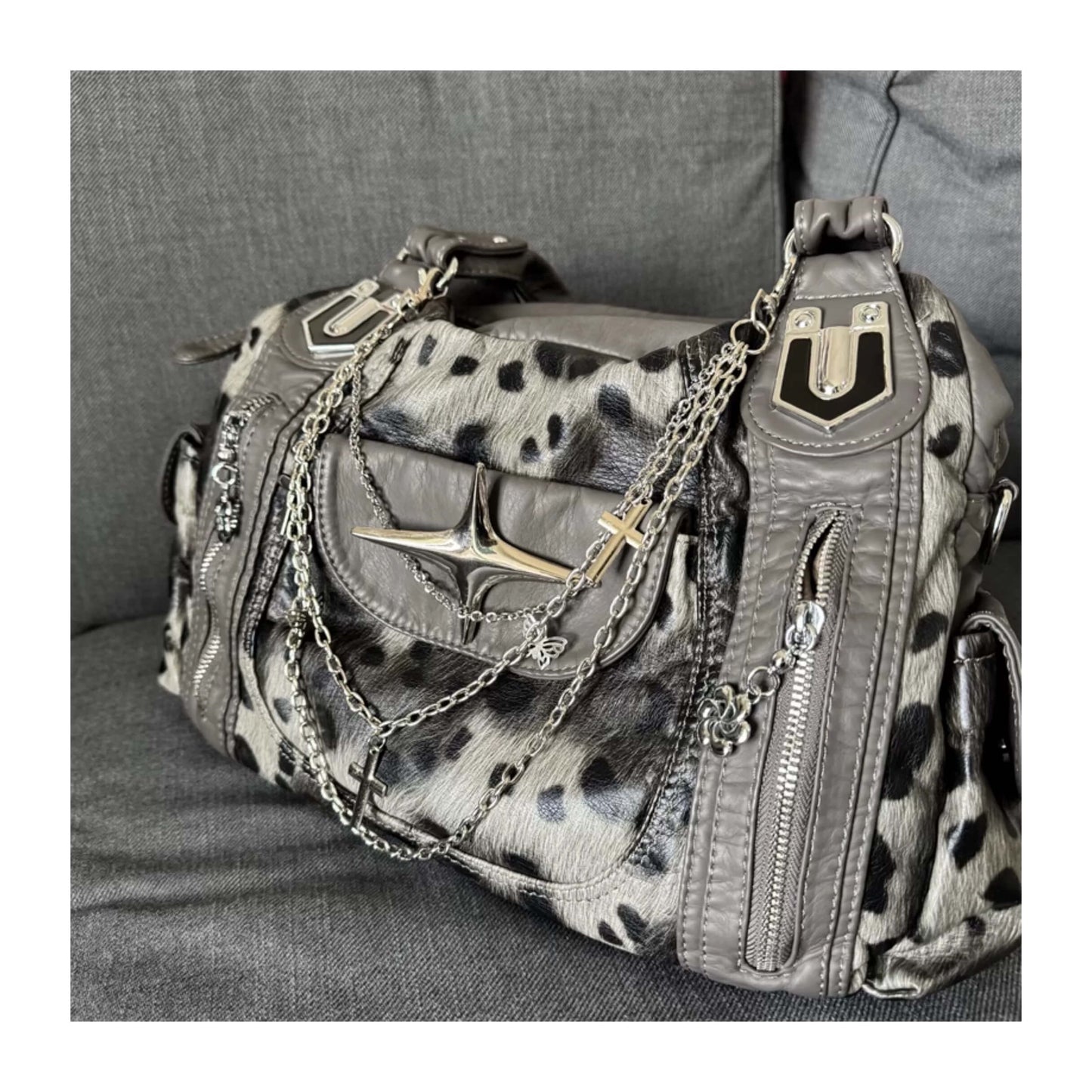 Leopard print handbag with chain details on a gray surface