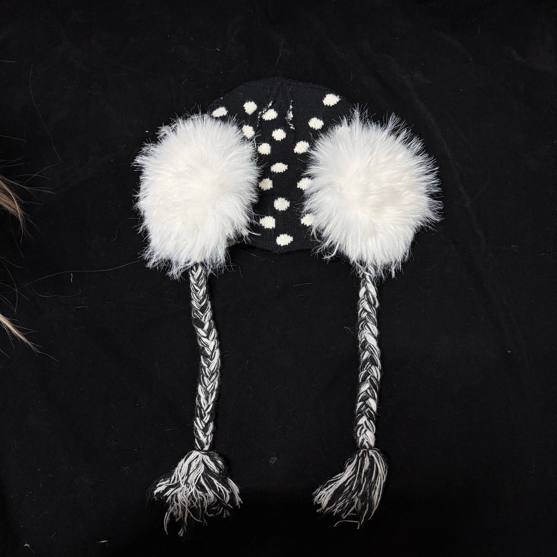 Black and white polka dot knit earflap hat with big white fur pom poms y2k aesthetic