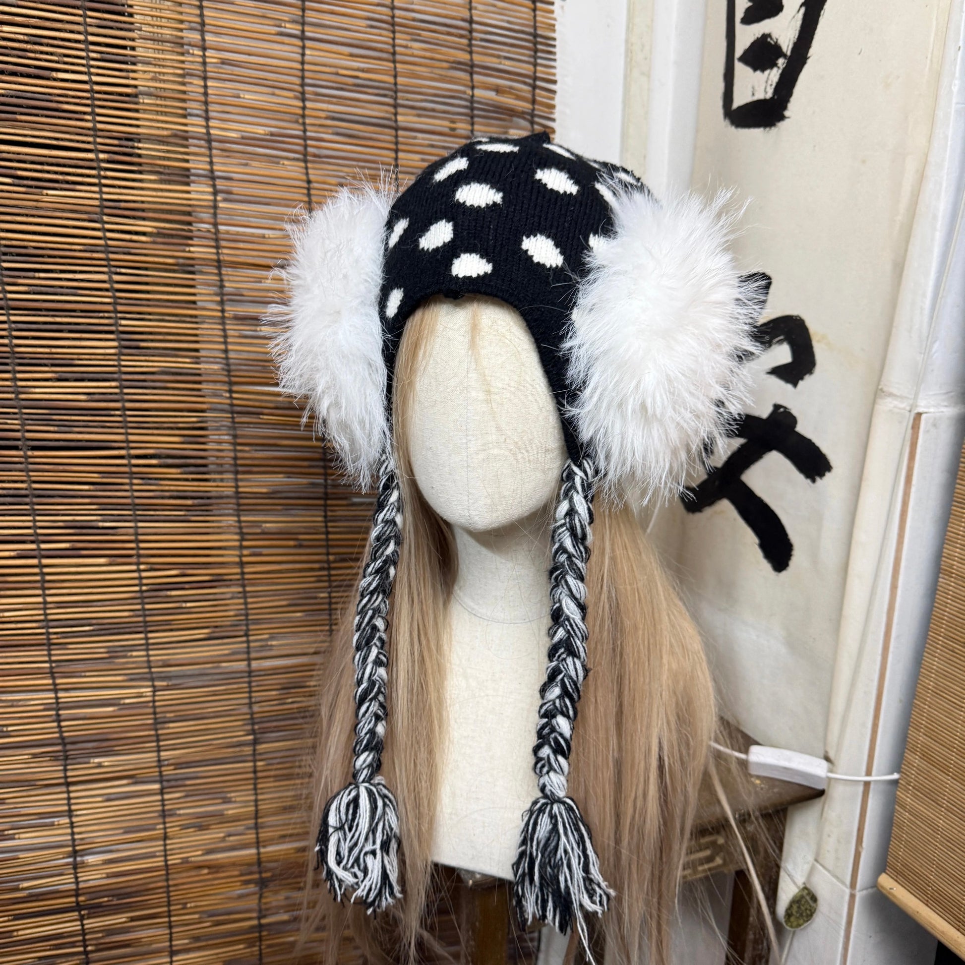 Black and white polka dot knit earflap hat with big white fur pom poms y2k aesthetic