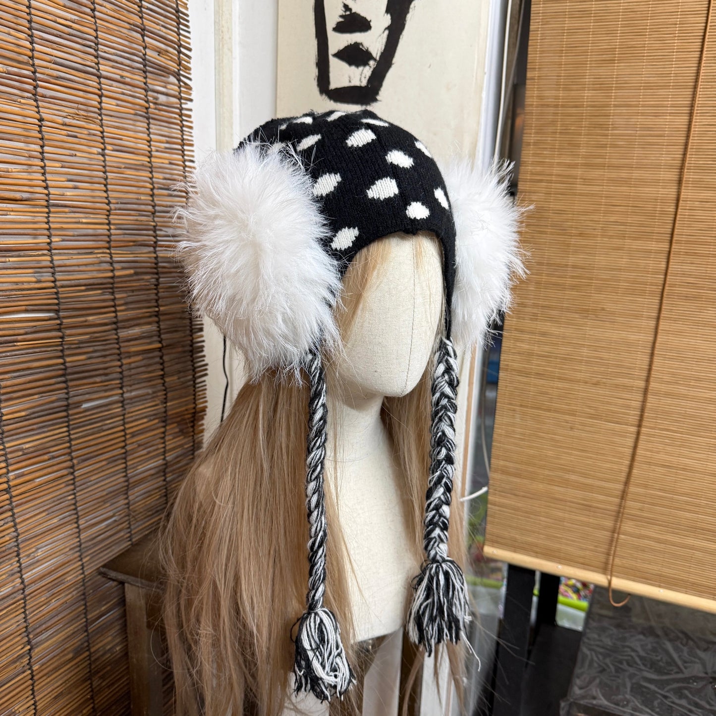 Black and white polka dot knit earflap hat with big white fur pom poms y2k aesthetic