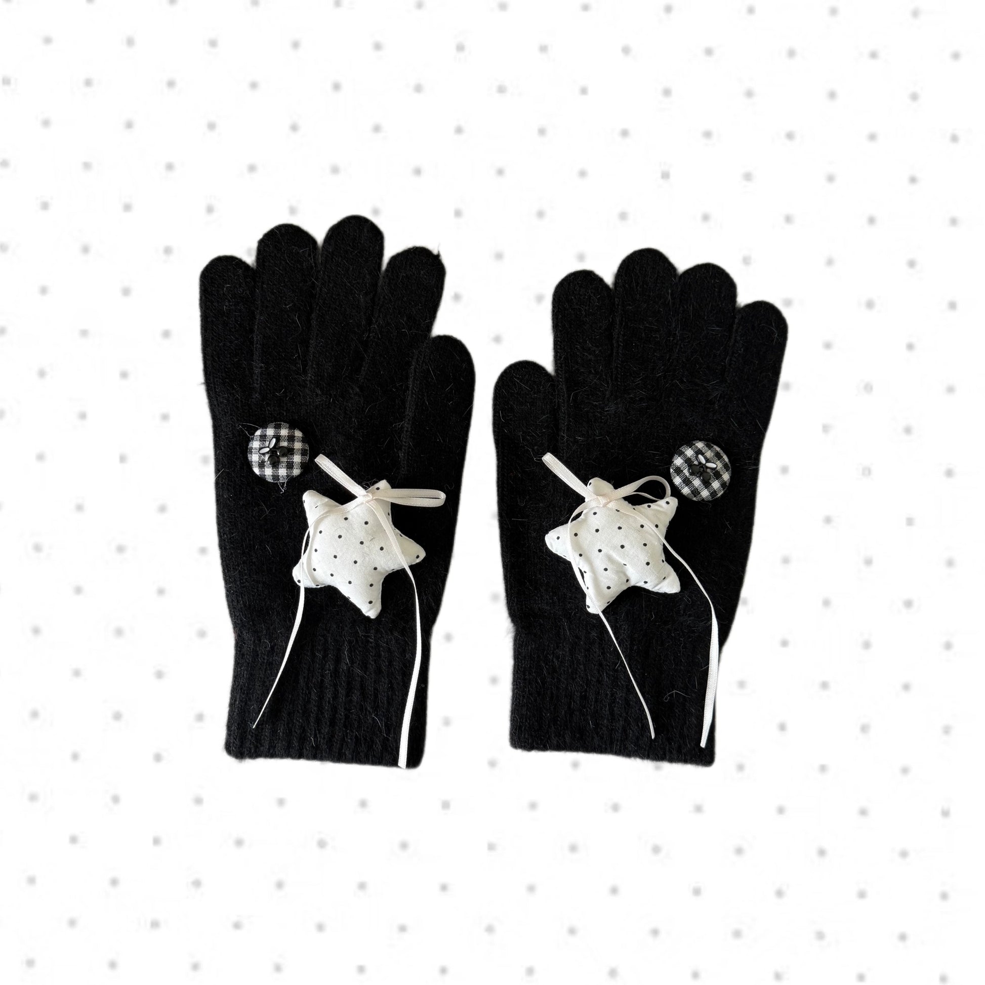 Black knit gloves with white stars and ribbon bows for Y2K grunge aesthetic.