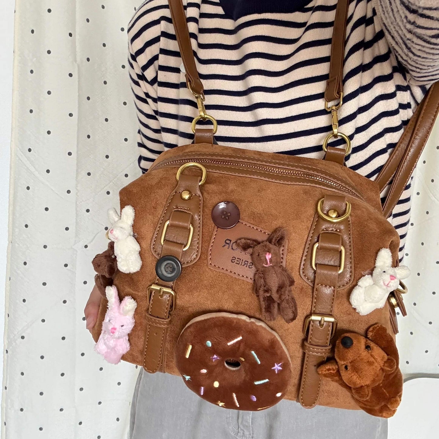 Kawaii brown faux suede backpack with 3D plushie bear, donut, and bunnies.
