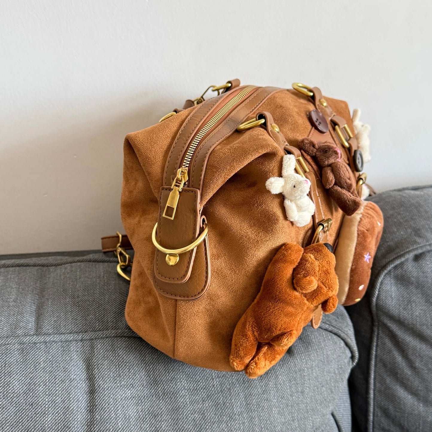 Kawaii brown faux suede backpack with 3D plushie bear, donut, and bunnies.