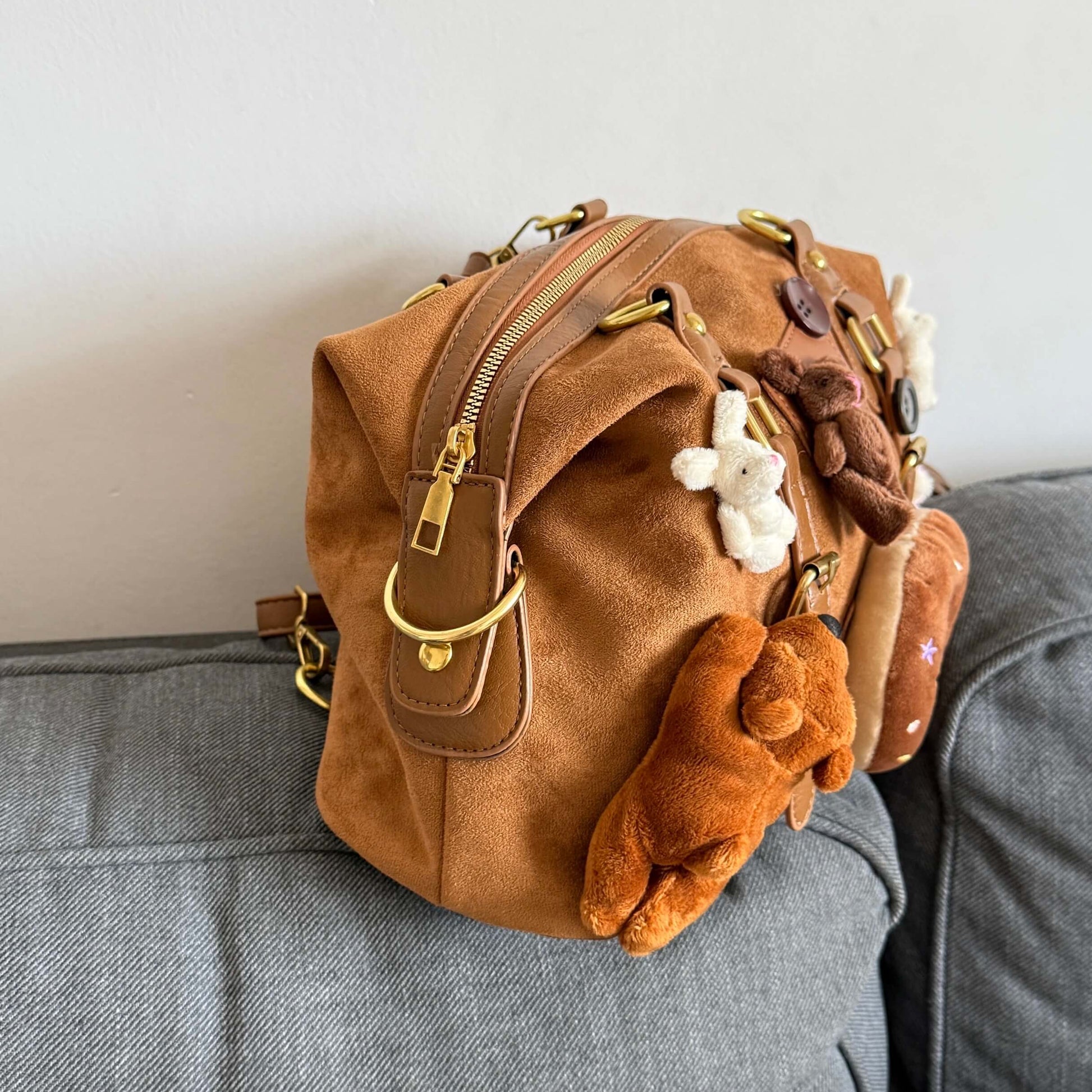 Kawaii brown faux suede backpack with 3D plushie bear, donut, and bunnies.