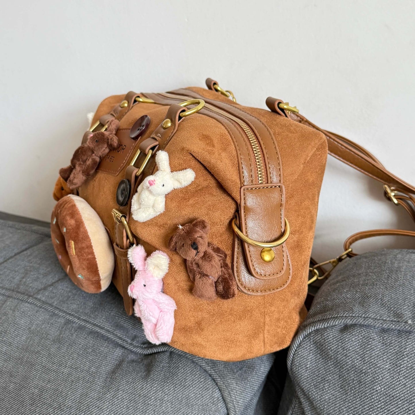 Kawaii brown faux suede backpack with 3D plushie bear, donut, and bunnies.