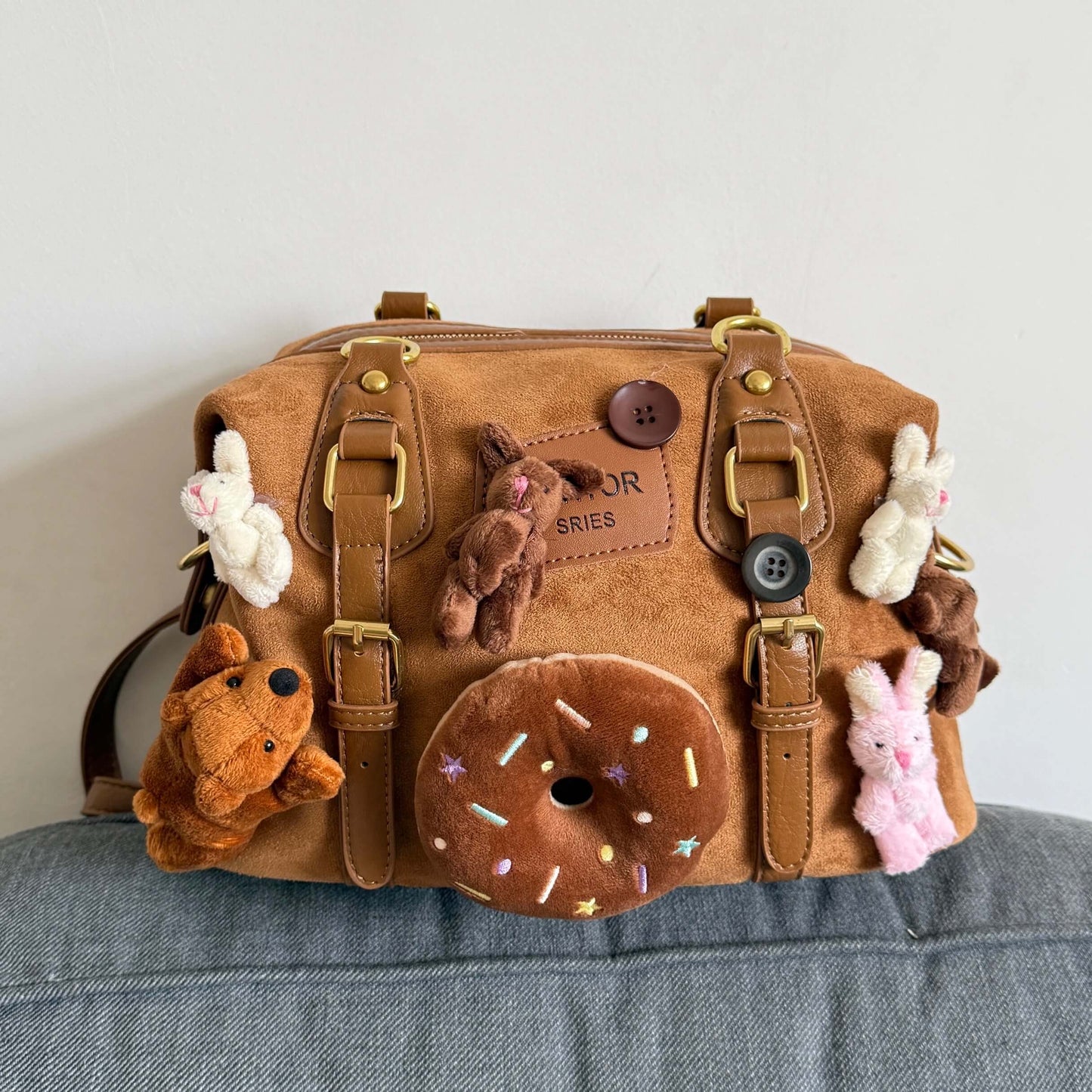 Kawaii brown faux suede backpack with 3D plushie bear, donut, and bunnies.