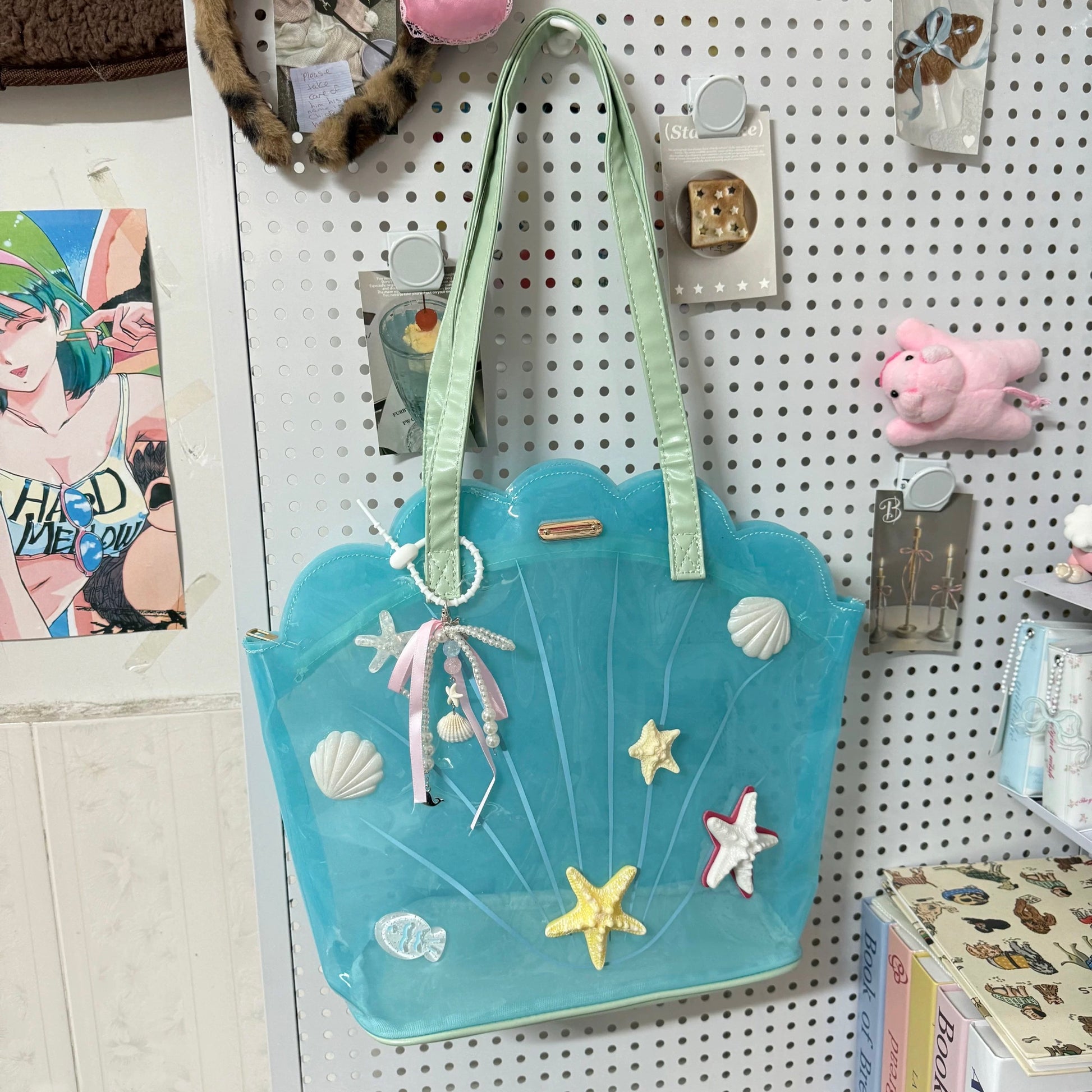 Clear aqua blue shell-shaped jelly tote bag with 3D starfish, seashells, and pearl ribbon charm.