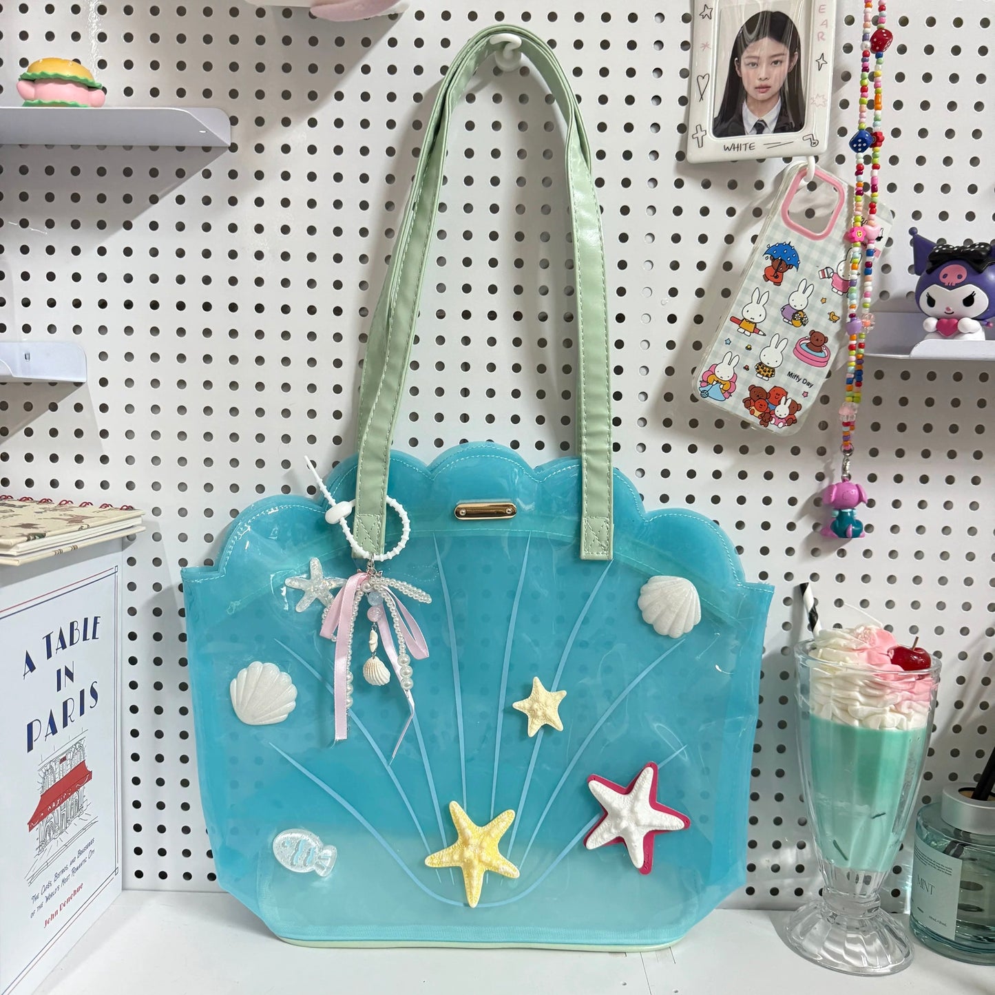 Clear aqua blue shell-shaped jelly tote bag with 3D starfish, seashells, and pearl ribbon charm.