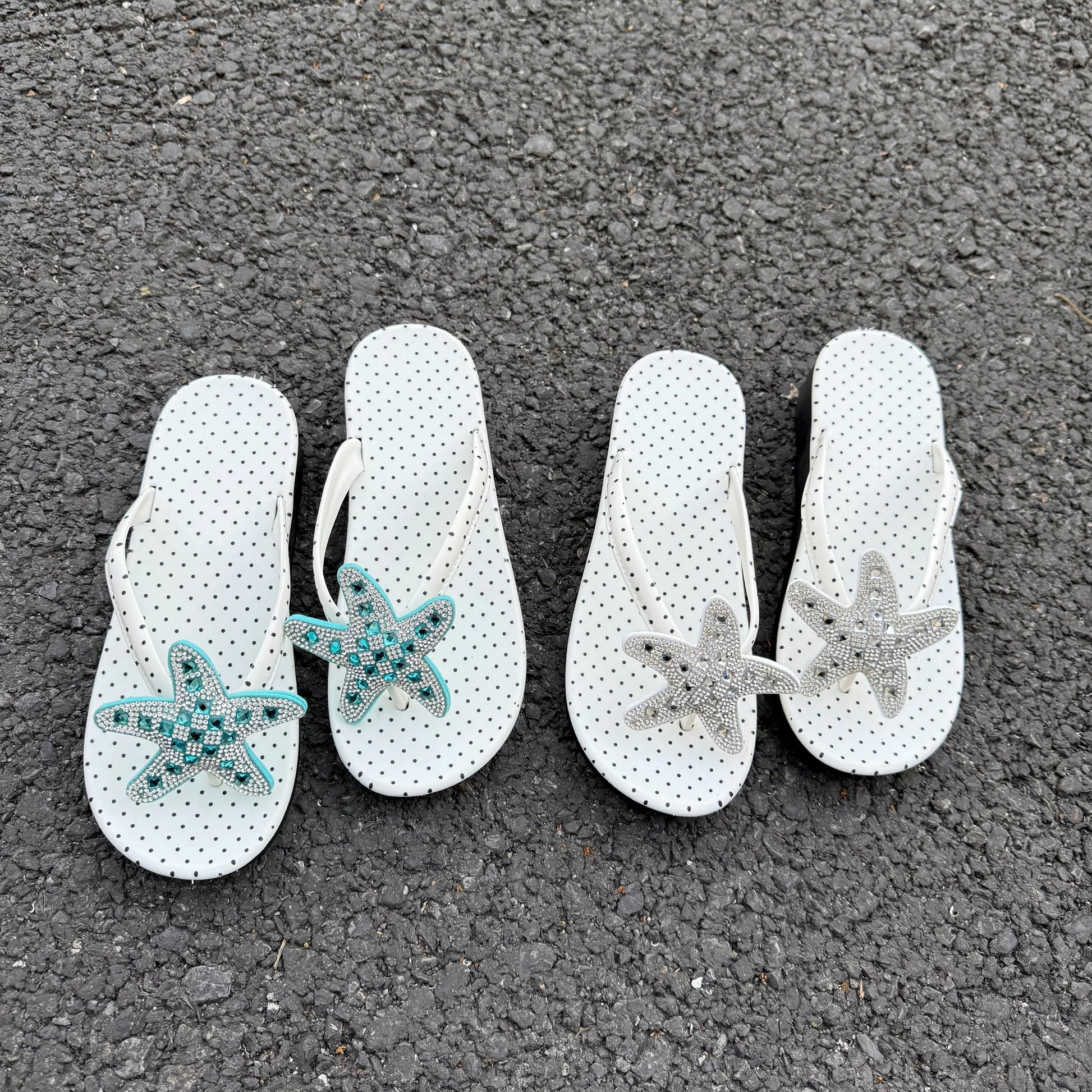 White polka dot flip flops with large jeweled turquoise starfish on sand