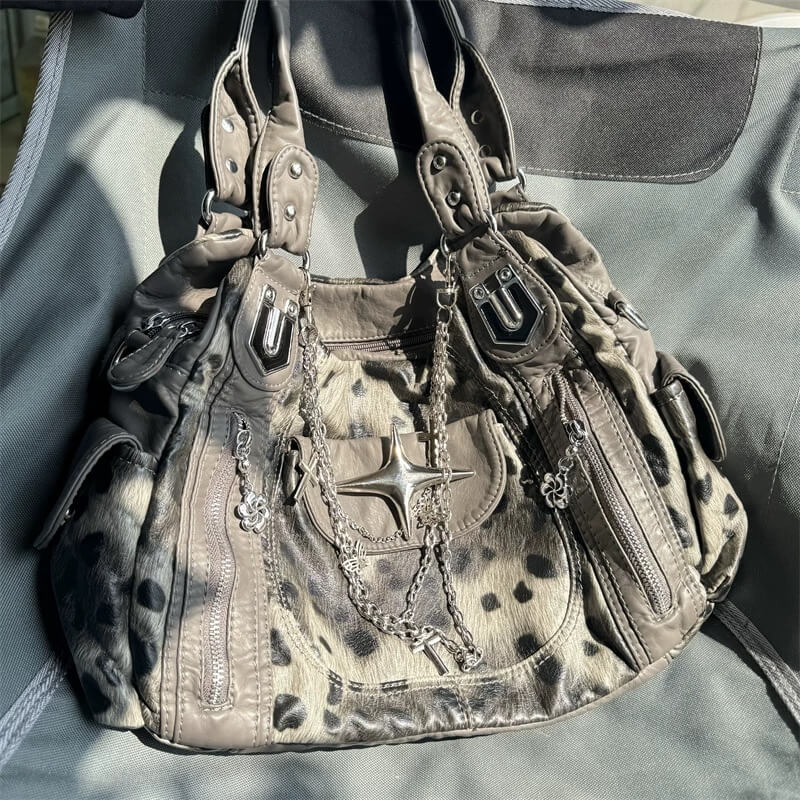 Leopard print handbag with chain detail on a gray background