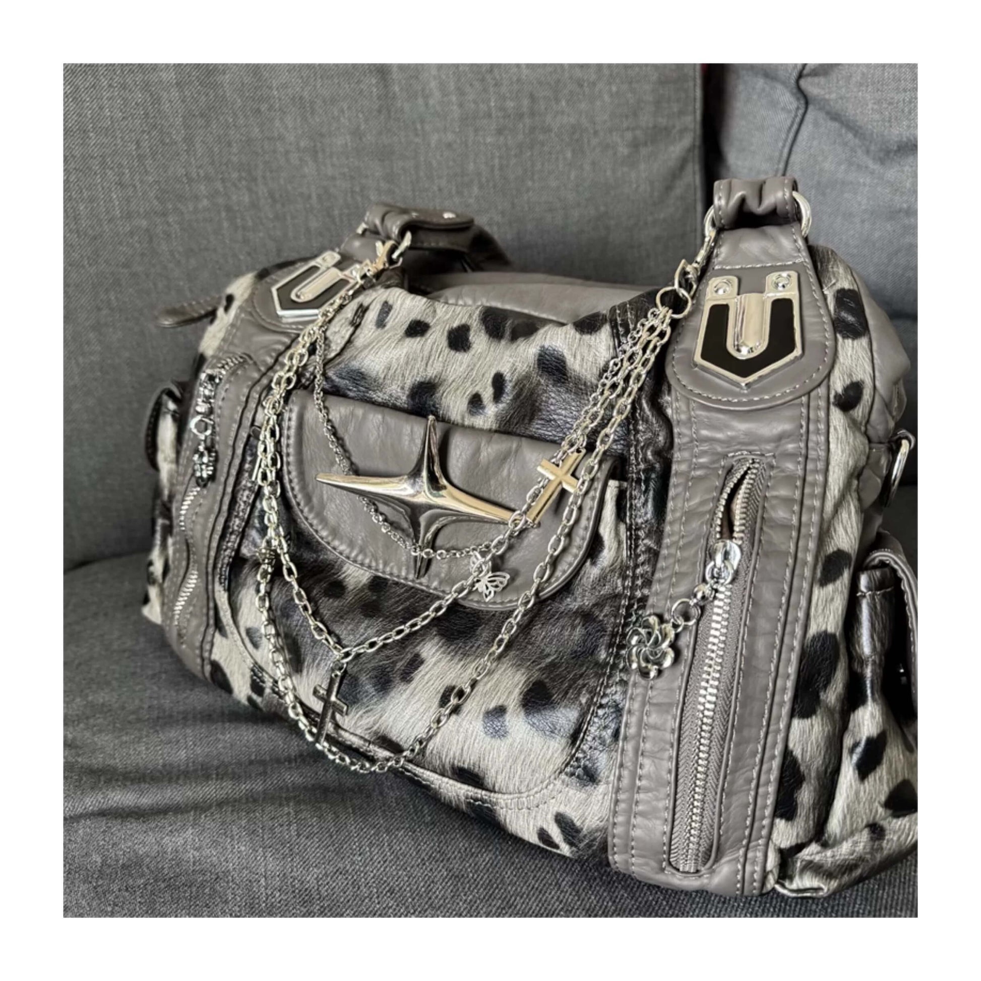 Leopard print handbag with chain details on a gray surface